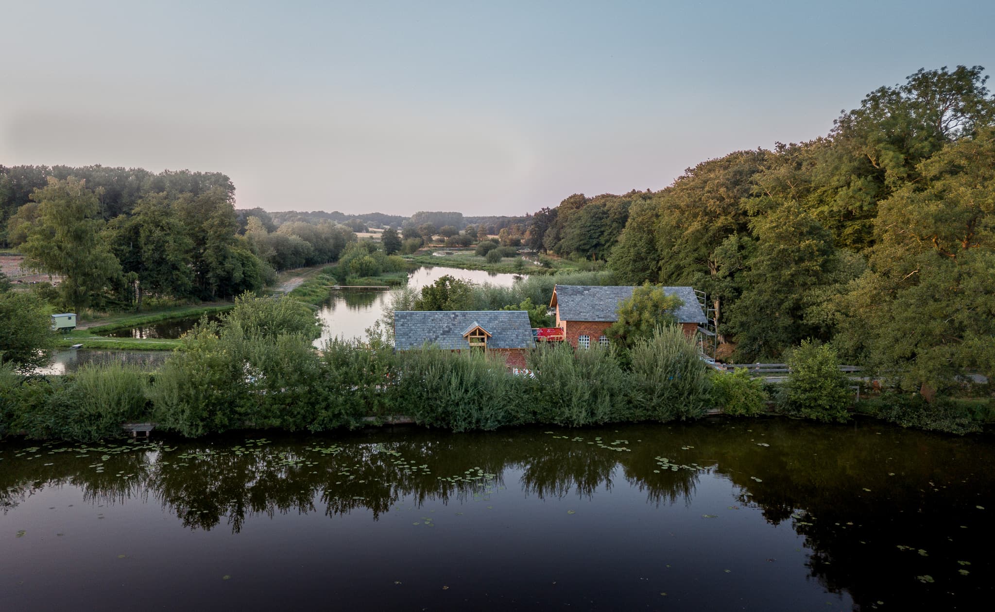 Wassermühle in der Seitenansicht aus der Luft, am Wasserlauf der Pulser Au